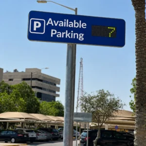 Smart parking flip-dot guidance signage 7x20 on outdoor pole showing available parking with yellow-green dot display